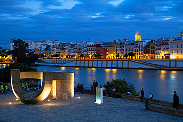 Waterfront view of Seville at night, along the Rio Guadalquivir, Seville, Andalucia, Spain, Europe