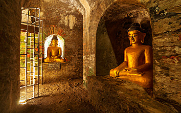 Buddha statues in the underground brick-lined corridors of Htukkant Thein Temple, Mrauk U, Rakhine, Myanmar (Burma), Asia