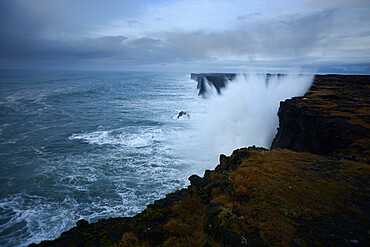 Saxholsbjarg cliff being hit by large waves, Iceland, Polar Regions