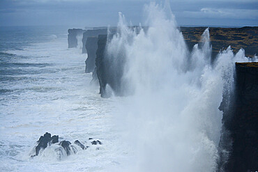 Saxholsbjarg cliff being hit by large waves, Iceland, Polar Regions