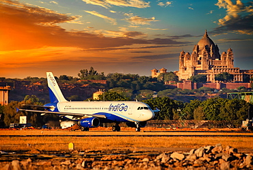 Indigo Airlines, Indian low cost carrier rolling out from Jodhpur Airport with the famous Umaid Bhawan Palace in background, Rajasthan, India, Asia