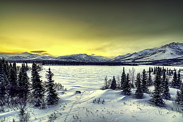 Sunrise over the frozen Otto Lake and snowy mountains of Denali National Park in the background, Alaska, United States of America, North America