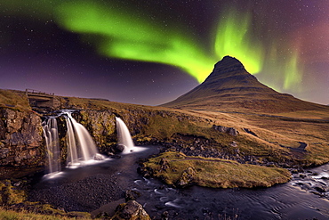 Aurora Borealis (Northern Lights) over Kirkjufell Mountian with a small waterfall in Iceland, Polar Regions