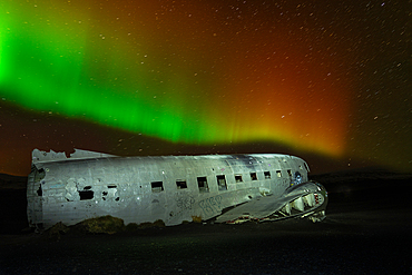 A crashed DC-3 aircraft under the Northern Lights (Aurora Borealis) in Iceland, Polar Regions