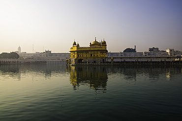 The Golden Temple at sunrise through fog, Amritsar, Punjab, India, Asia