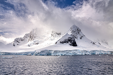 Snow-covered mountains at the mouth of the Lemaire Channel, Antarctic Peninsula, Polar Regions