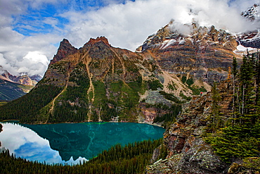 Lake O'Hara, and man looking over the edge on the far right side of the cliff, Yoho National Park, UNESCO World Heritage Site, British Columbia, Canada, North America