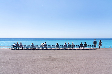 Line of people on chairs looking out to the sea, Nice, Alpes Maritimes, Cote d'Azur, French Riviera, Provence, France, Mediterranean, Europe