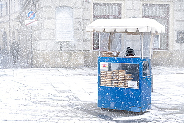 Traditional Krakow bagel seller in the snow located at the City Square, Krakow, Poland, Europe