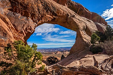 Desert landscape viewed through Partition Arch, Arches National Park, Utah, United States of America, North America