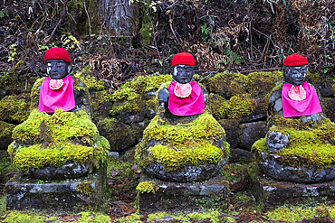 Narabi Jizo Buddha statues with red hat covered with Moss in Nikko, Tochigi, Honshu, Japan, Asia