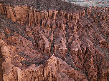 Drone view of Kok-Moinok Canyon, a clay-sand structure formed on the slopes of arid mountains cut by water streams, Kyrgyzstan, Central Asia, Asia