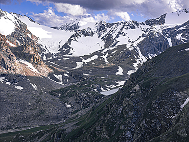 Snow-capped peaks and lush valleys at sunset showcased in a stunning landscape, Kyrgyzstan, Central Asia, Asia