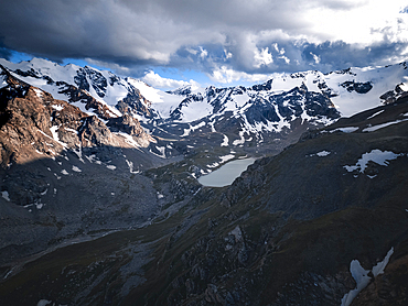 Snow-capped peaks and lush valleys at sunset showcased in a stunning landscape, Kyrgyzstan, Central Asia, Asia