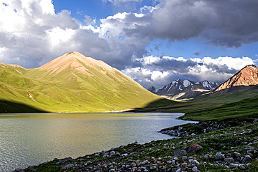 Kol-Ukok mountain lake at sunset surrounded by green mountains under a cloudy sky, Kyrgyzstan, Central Asia, Asia