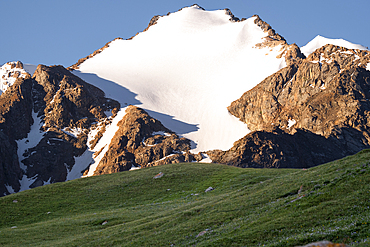 Snow-capped peaks rise above green Valleys in beautiful Kyrgyzstan, Central Asia, Asia