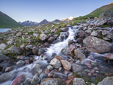 A stream falling down towards Kol Ukok lake in the mountains of Kyrgyzstan