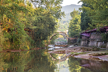 The famous ancient arch stone bridge in Shangli Town at sunrise