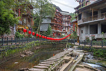 Red lanters and a stone path over the river in Shangli town
