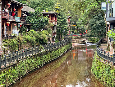The river passing by wooden houses in Shangli Town