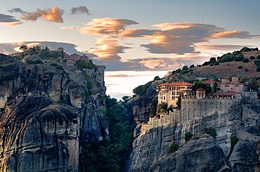 Sunset light on clouds and Varlaam and Megalo Meteoro Monasteries, Meteora, UNESCO World Heritage Site, Thessaly, Greece, Europe