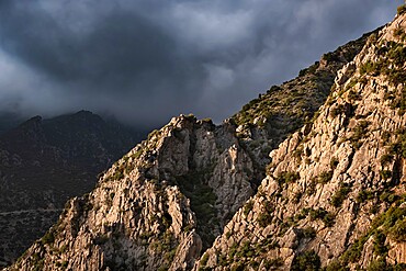 Sunset light on a rocky mountain and dark clouds in the sky, Chefchaouen, Morocco, North Africa, Africa