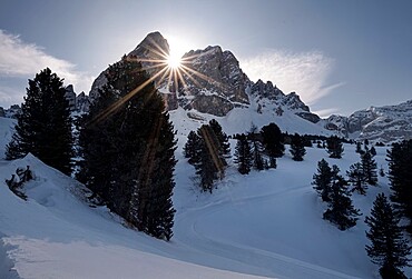 Dolomites snowy winter landscape of the Sass the Putia with a sun star between rocks, Trentino-Alto Adige, Italy, Europe