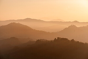 Sunset light reflected in the mist on countryside hills, Emilia Romagna, Italy, Europe