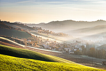 Sunrise light in the mist on gentle hills in the countryside, Emilia Romagna, Italy, Europe