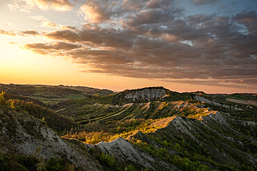 Sunset above badlands and countryside with colored clouds in the sky, Bologna, Emilia Romagna, Italy, Europe