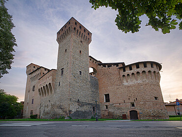 Medieval castle of Vignola with fortified tower, framed by tree branches, Vignola, Emilia Romagna, Italy, Europe