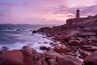 Pink sunset long exposure at Ploumanac???h lighthouse with the pink granite coast in Brittany. France