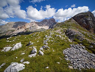 Rocks and stones on Croda de R'Ancora with a view on Croda Rossa d'Ampezzo in the background with a blue sky with white clouds