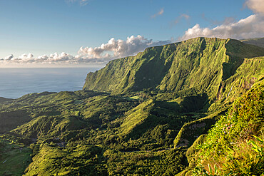 View at sunset of the mountains on the west side of Flores with lush green vegetation and some clouds, Flores Island, The Azores, Portugal, Atlantic