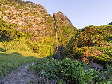 Waterfall, Poco do Bacalhau, at sunset on Flores island, Azores Islands, Portugal, Atlantic Ocean, Europe