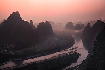 Pink sunrise on the Li River and the famous Yangshuo mountains, Yangshuo, Guangxi, China, Asia