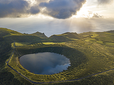 Aerial view of Caldeira Rasa lake on Flores island and the sunset over the sea, Azores islands, Portugal, Atlantic, Europe