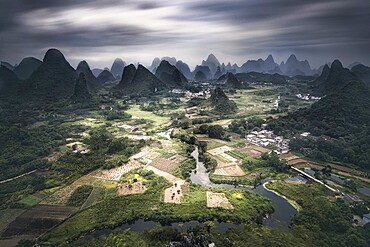 Long exposure of Yangshuo mountains with dark clouds, Yangshuo, Guangxi, China, Asia