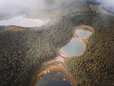 Aerial view of Lagoa Empadadas, Lagoa do Eguas and Lagoa Rasa lakes with low clouds and pine trees forest, Sao Miguel island, Azores islands, Portugal, Atlantic, Europe