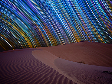 Star trail over the sand dunes of Rub al Khali desert, Oman, Middle East