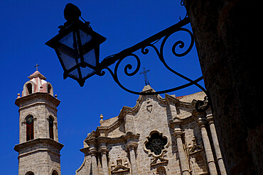 Historic church behind the silhouette of an iron lantern, Old Havana, Cuba, West Indies, Central America