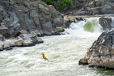 Ian Brown stand up paddle surfs challenging whitewater below Great Falls of the Potomac River, border of Virginia and Maryland, United States of America, North America