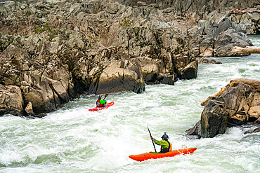 Whitewater kayakers run the last drop of the Fishladder on the Great Falls of the Potomac River, Maryland, United States of America, North America