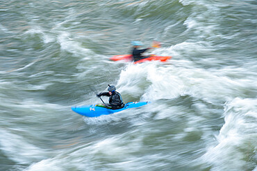 A kayaker surfs big standing waves of the Potomac River near Great Falls in his whitewater boat, Virginia, United States of America, North America