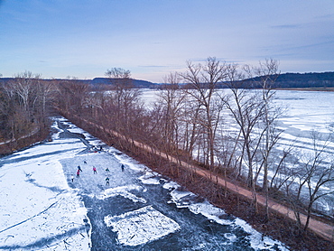 Ice skaters in a pond hockey game on the frozen C and O Canal (Chesapeake and Ohio Canal) next to the Potomac River, Maryland, United States of America, North America