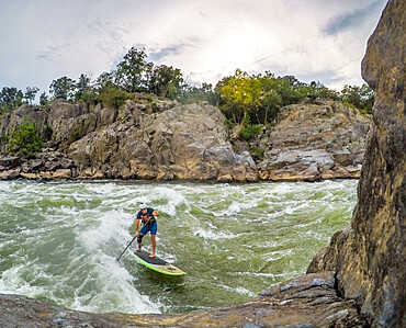 Skip Brown surfs Odeck wave below Great Falls on the Potomac River, Virginia, United States of America, North America