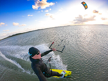 Photographer Skip Brown kiteboards on flat water on Chesapeake Bay at Hampton, Virginia, United States of America, North America