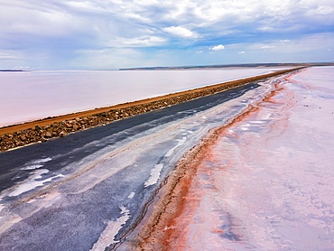 Tuz salt lake road drone aerial view with beautiful pink and black salt colours, in Turkey