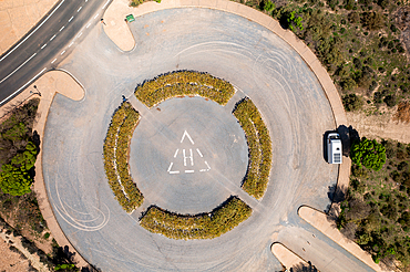 Drone aerial view of a helicopter landing parking on a desert like landscape at Francisco Abellan Dam, Granada, Andalusia, Spain, Europe