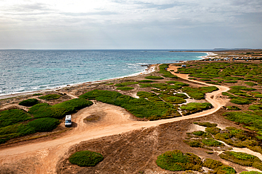 Camper van with solar panels on the roof parked in Su Bardoni beach, Sardinia, Italy, Mediterranean, Europe